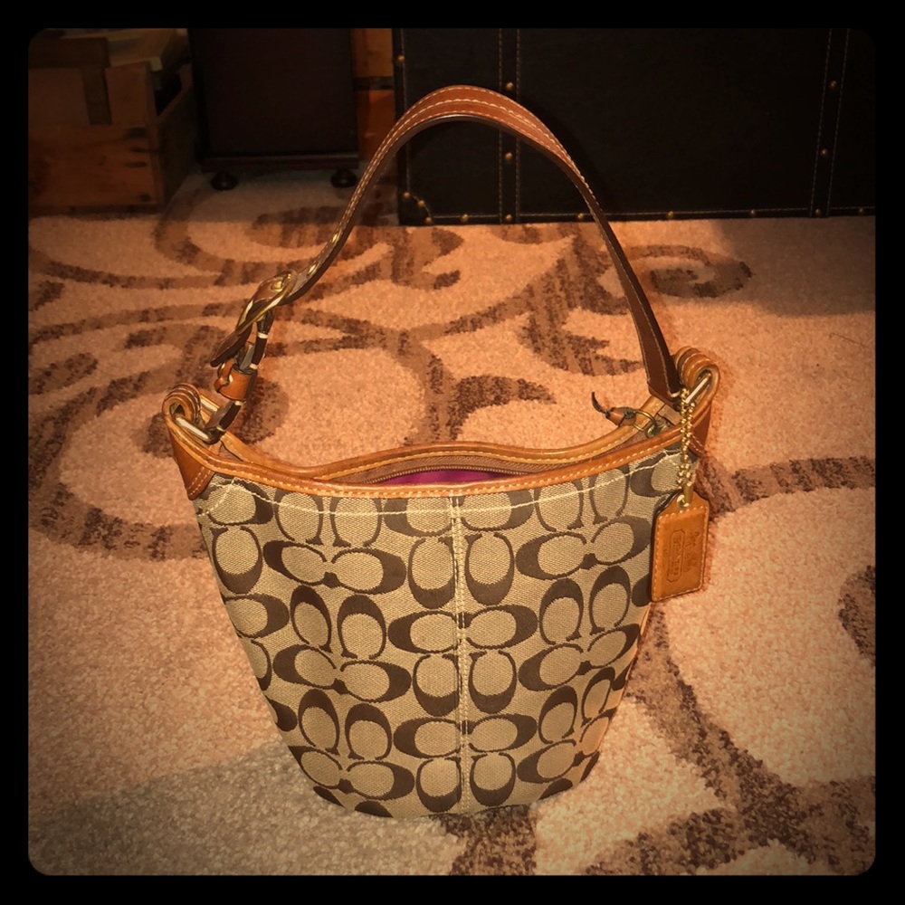 Coach bucket bag, fuchsia silk lining, classic.